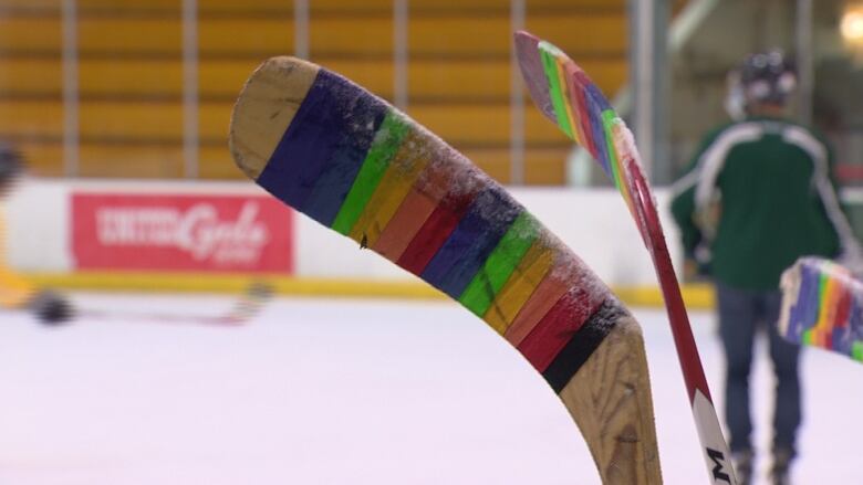 Hockey sticks wrapped in rainbow coloured tape