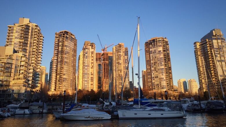 The sun sets on Vancouver's Yaletown neighbourhood with high rises pictured.