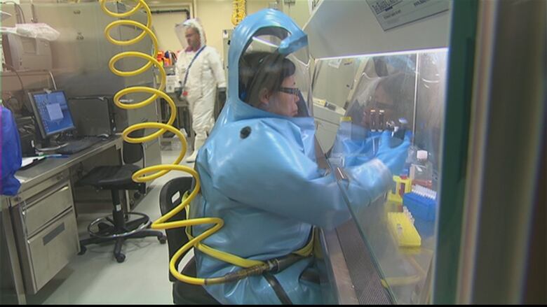 Workers at Winnipeg's National Microbiology Laboratory wear protective suits designed to keep dangerous microbes out.