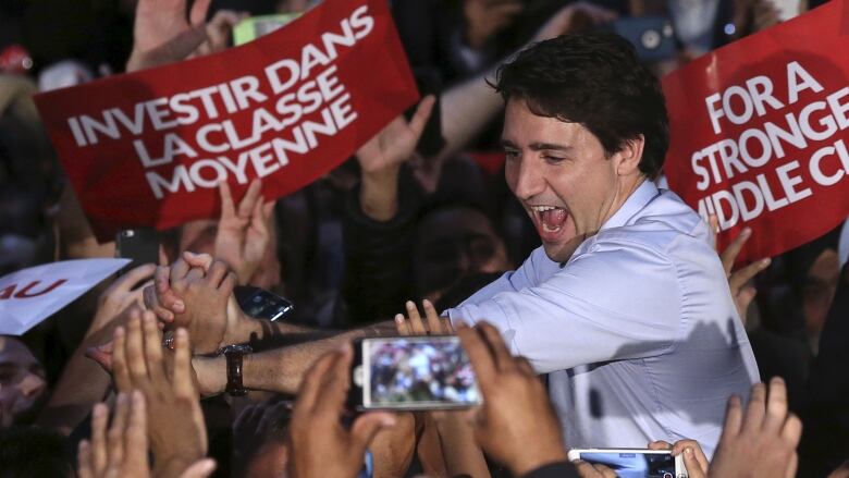 Justin Trudeau is surrounded by supporters at a Liberal campaign event.