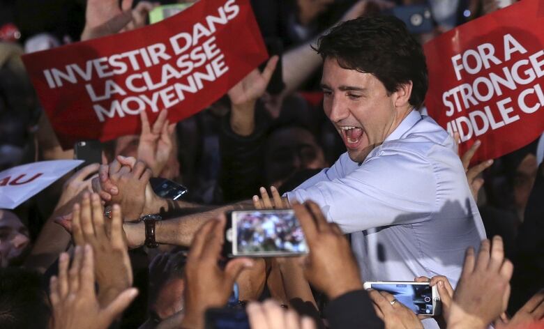 Justin Trudeau is surrounded by supporters at a Liberal campaign event.