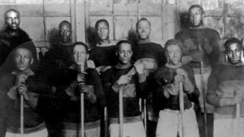 Historic Black hockey players pose for a photo together.