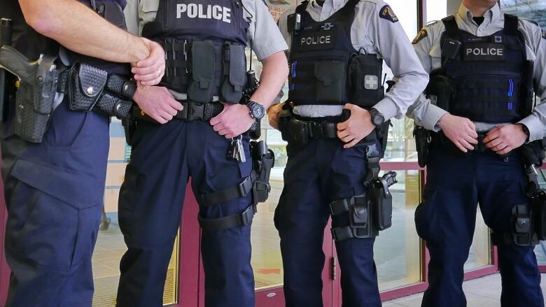 Members of the North Vancouver RCMP wear plain navy cargo pants, removing the traditional yellow stripe in protest.