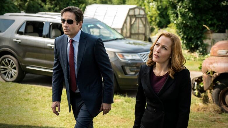 This photo provided by FOX shows, David Duchovny, left, as Fox Mulder and Gillian Anderson as Dana Scully in an episode of 