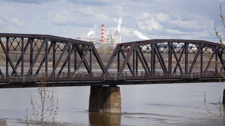 A mill behind a bridge.