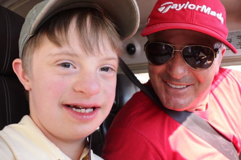 Dimitri Neonakis is shown at the controls of his plane. His passenger is 13-year-old Billy Holt.