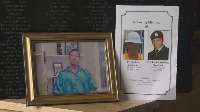 A framed photo of Lionel Desmond next to a photo of his mother, Brenda.