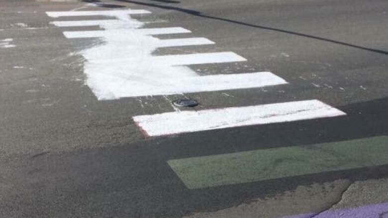 A defaced crosswalk in Woodstock