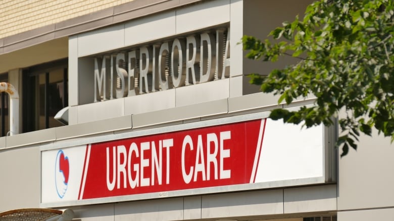 A building says Misericordia in the cement on the side, and a sign underneath says 