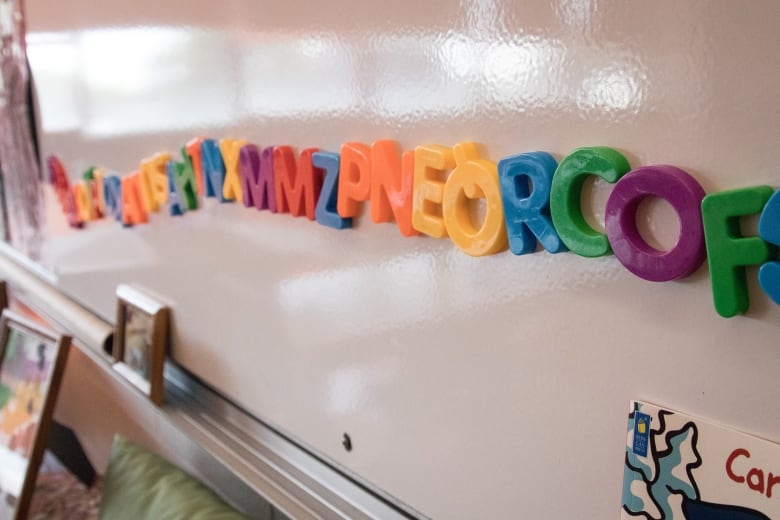 Magnetic letters stick to a white board in a pre-primary classroom