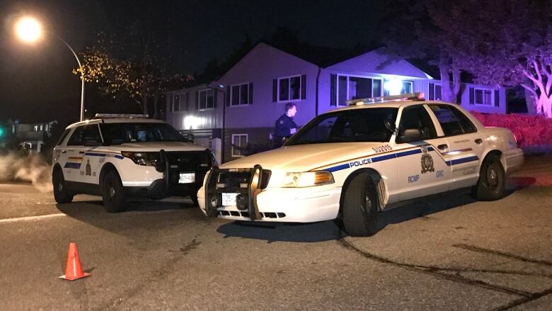 RCMP cruisers block off the scene of the shooting.