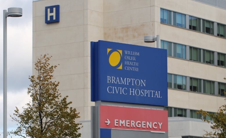 A sign for Brampton Civic Hospital is pictured with the hospital in the background.