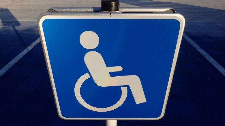 An accessible parking sign in blue