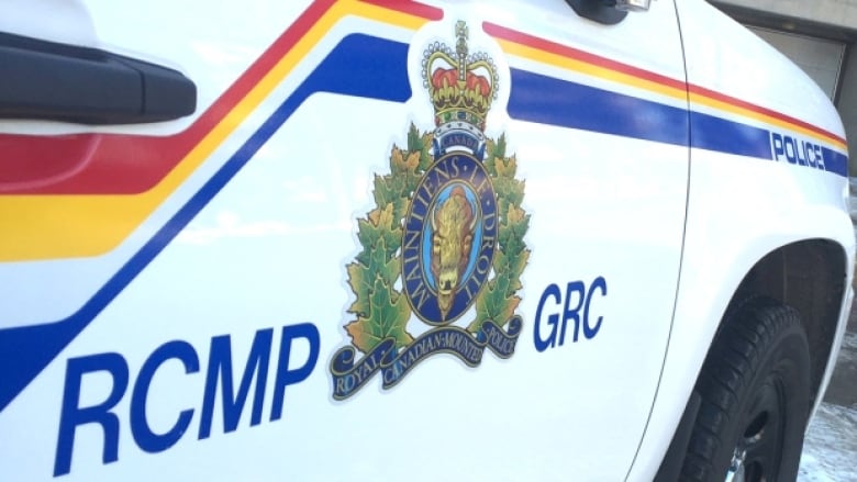 A white car with an RCMP logo on it.