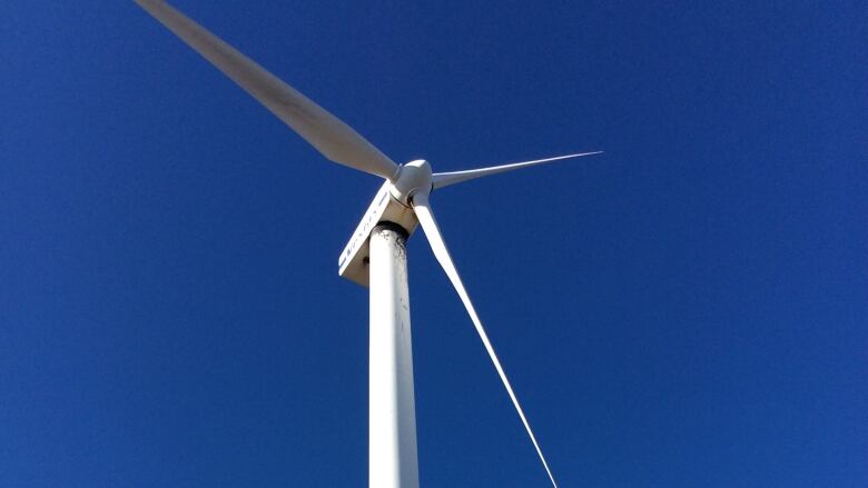 Wind turbine against a blue sky.