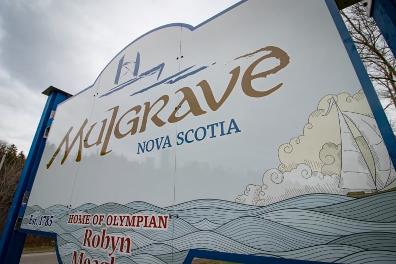 A white sign reading Mulgrave, Nova Scotia seen from below