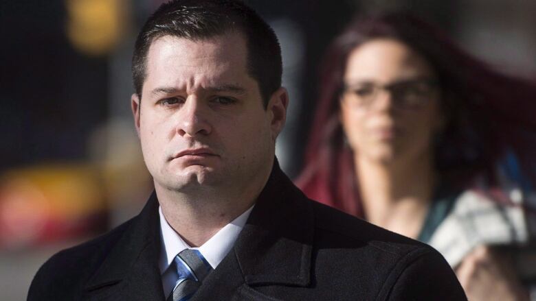 James Forcillo, wearing a black pea coat, walks into court.