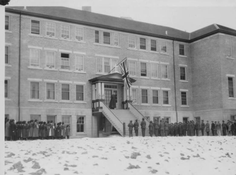 long lines outside a big brick building