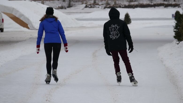 Two people ice skating.