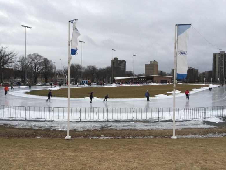 Snow surrounds an ice surface.