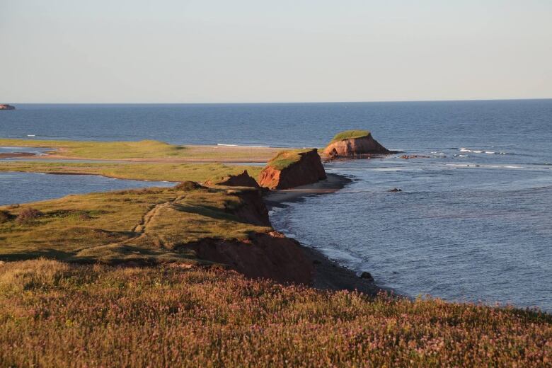 Red cliffs near a body of water. 