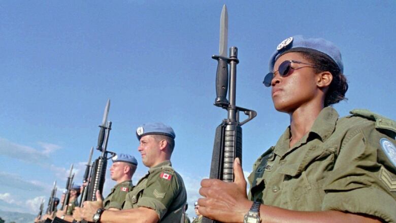 Canadian peacekeepers prepare for a parade at Maple Leaf Camp in Port-au-Prince on Nov. 28,1997. Canada is looking at ways to help other countries boost the number of female peacekeepers, despite having only a handful of Canadian women in blue helmets and berets.