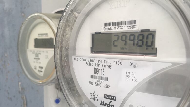 A close-up photo of a hydro meter on the side of a house. 