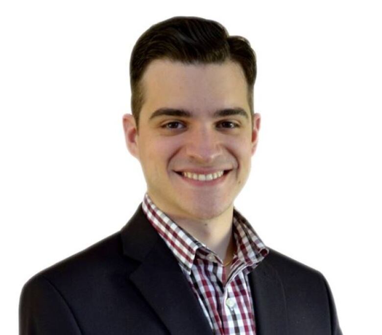 smiling young man wearing checked shirt and black jacket