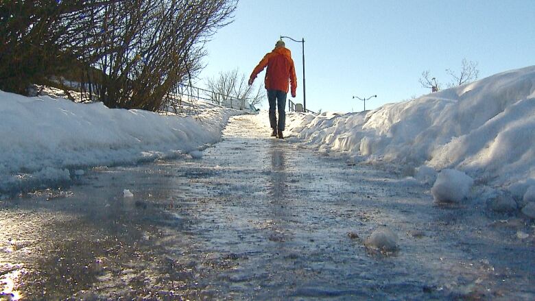 A person walking on an icy sidewalk