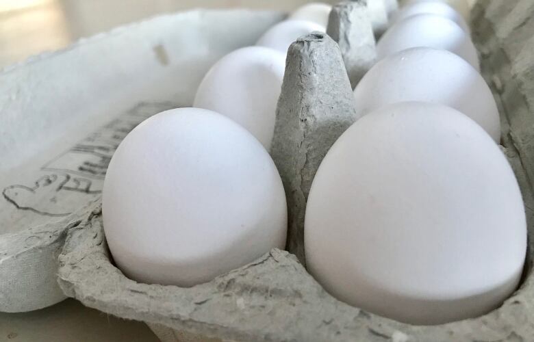 A close up of some eggs in a carton.