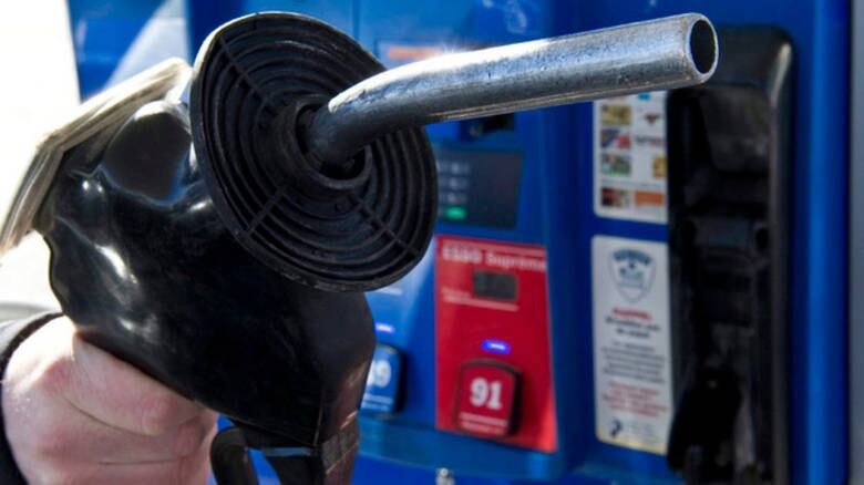 Close up of a hand holding a gas pump