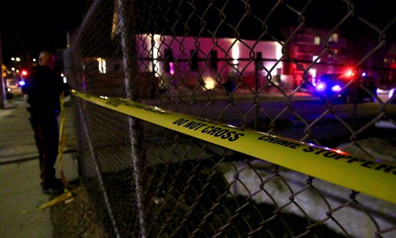 Police tape on a wire fence.