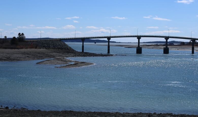 A bridge crossing deep blue water.