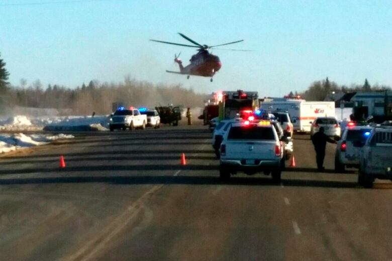 Helicopter hovers over highway filled with first responder vehicles