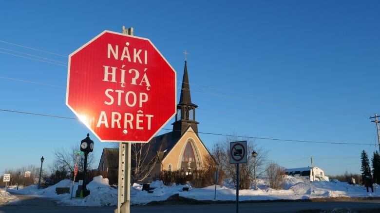 a stop sign in front of a church