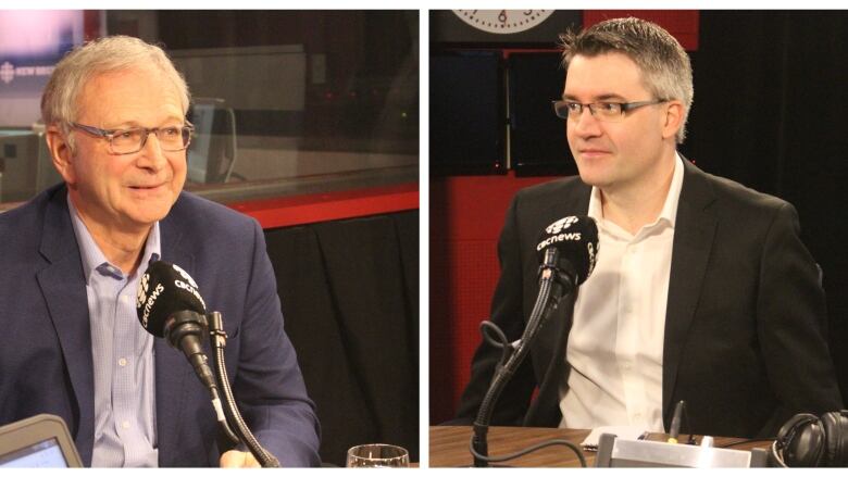 Two men in suits sitting behind a microphone.