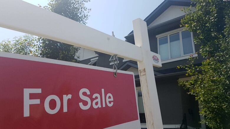 A sign advertises a home for sale in Calgary.