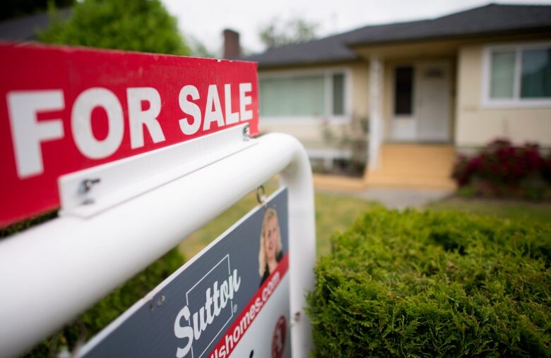 A 'For Sale' sign outside a home.