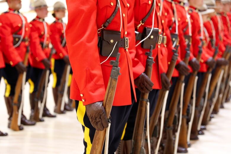 Royal Canadian Mounted Police (RCMP) cadets await badge presentations at a graduation ceremony at the RCMP Academy in Regina on June 5, 2017.