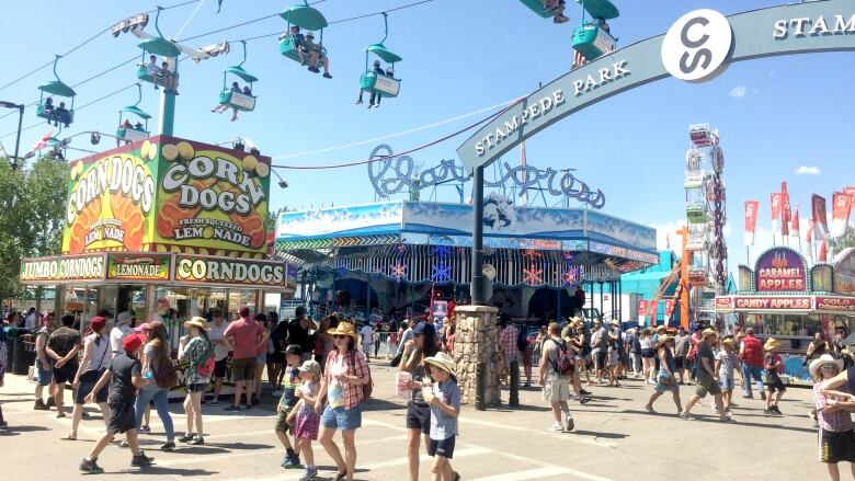 A busy crowd walking on the grounds of the Calgary Stampede.