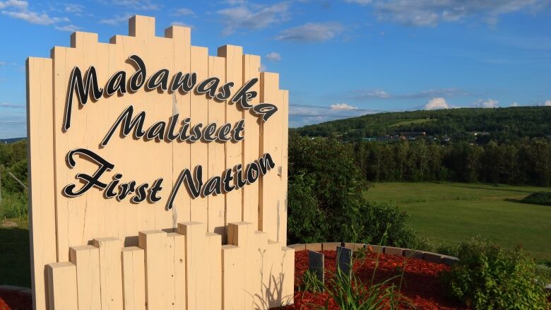 Outdoor wooden sign at entrance to First Nation. 