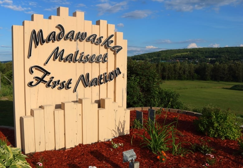 Outdoor wooden sign at entrance to First Nation. 