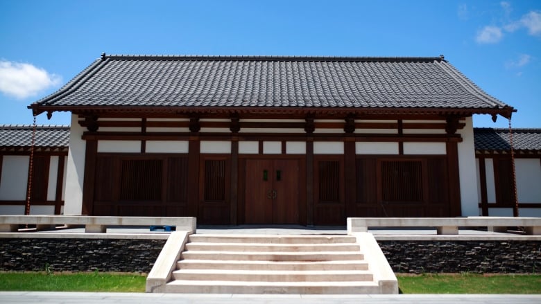 An architect's rendition of a building with a curving pagoda roof. 