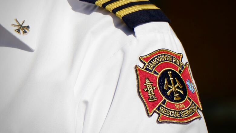 A man with a shoulder patch that reads 'Vancouver Fire and Rescue Services, 1886'.