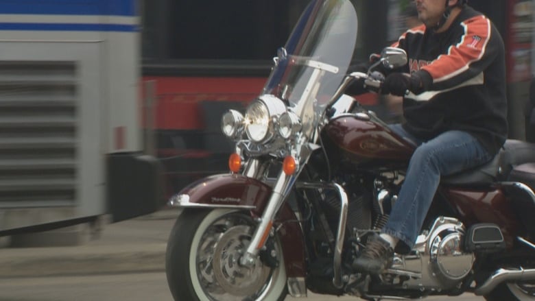 A man riding a motorcycle.