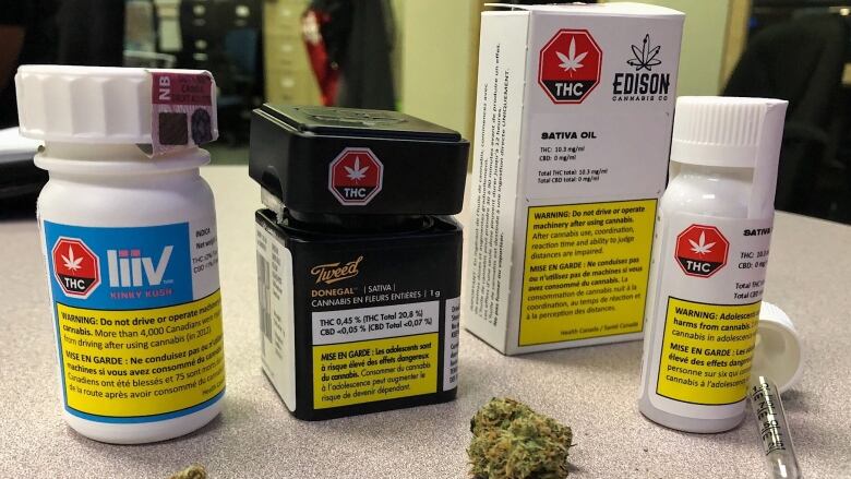 Four examples of legal cannabis packaging for Canada, all with a yellow warning label at the bottom.