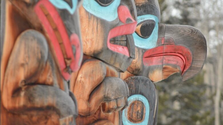 A close up of carved wooden totems.