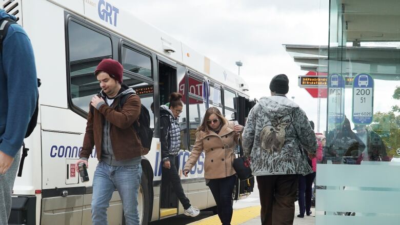 People getting of a public transit bus.