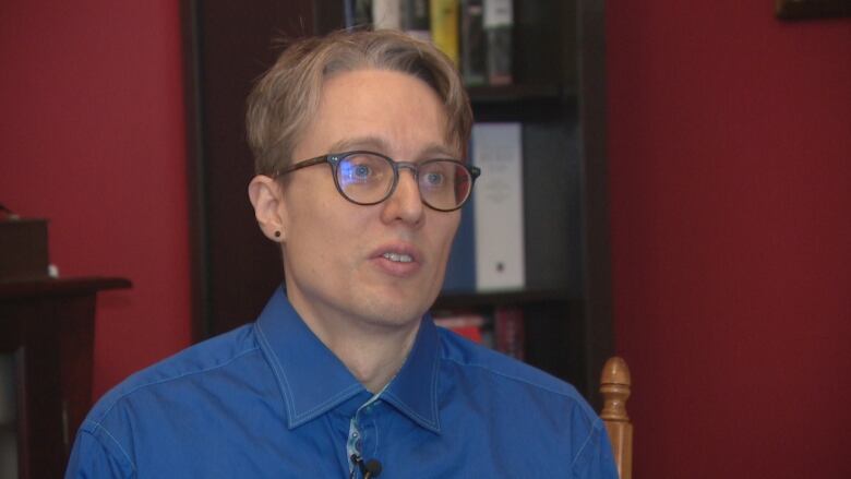 A man wears a blue shirt and tie.