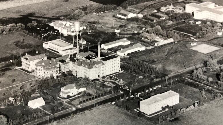 Black-and-white aerial photo of several buildings.